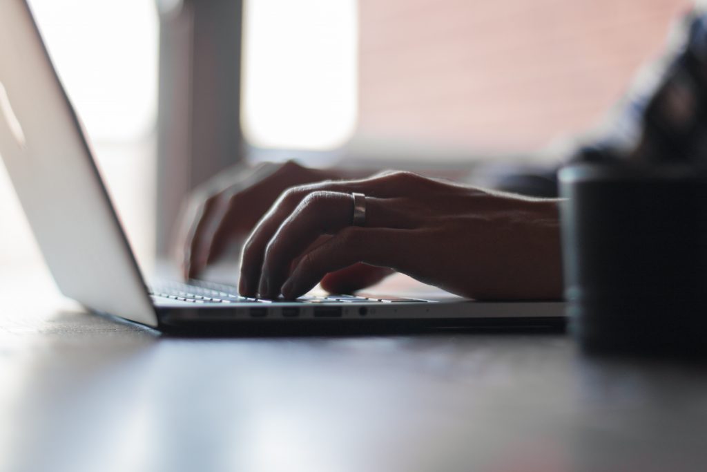 guy typing on his laptop 