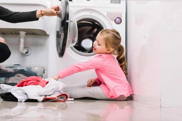 girl helping mom with laundry