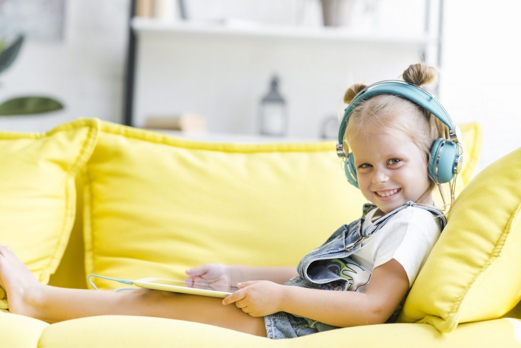 Child listening to song on headphones