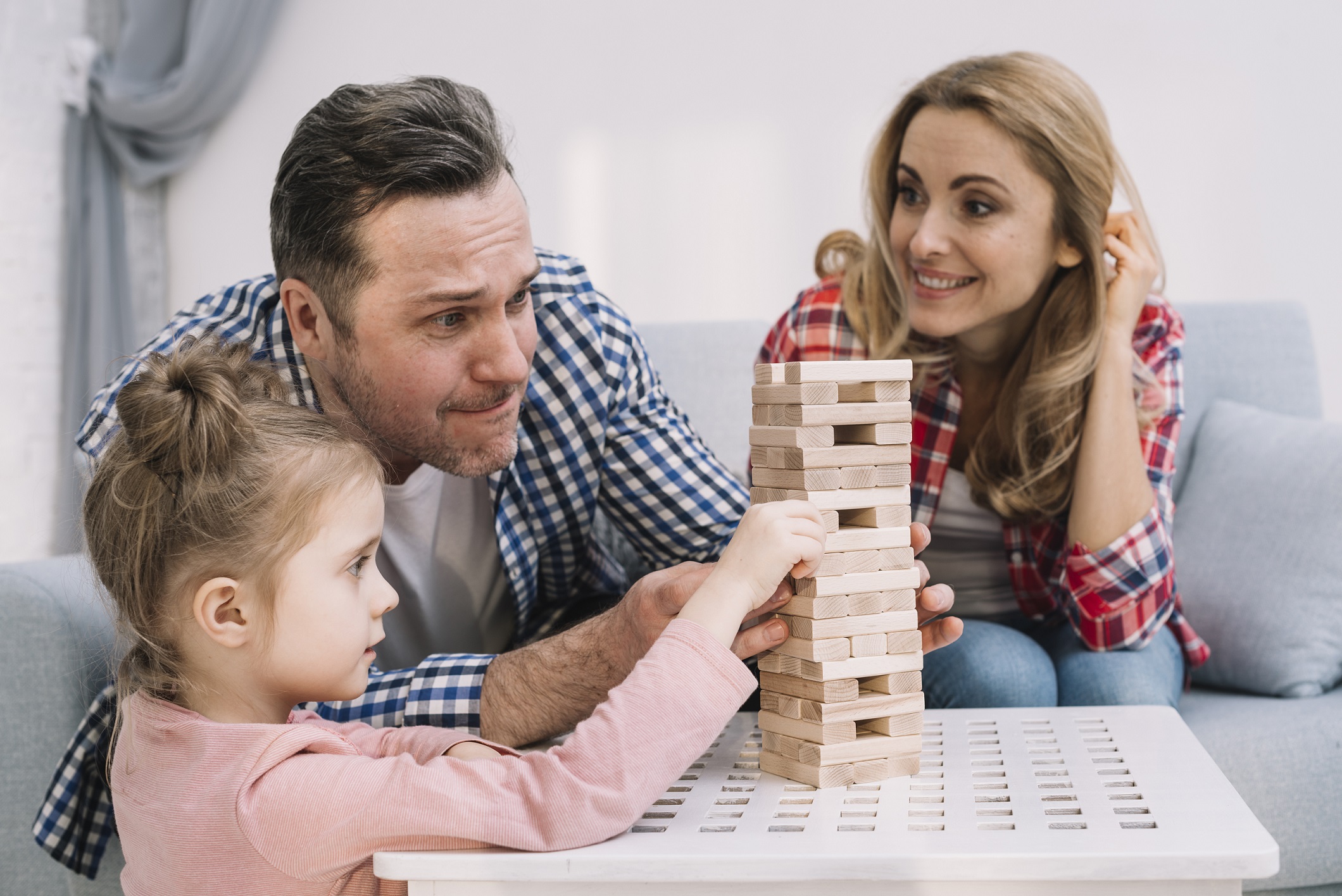 parents playing jenga with child
