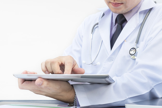 Doctor is working with tablet over white background