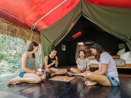 People playing a board game in the 'tendok'