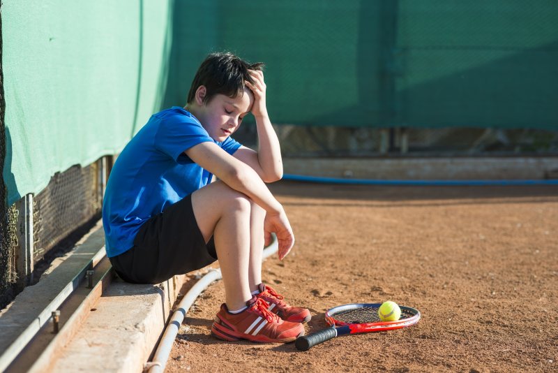 Boy sad and alone during sports