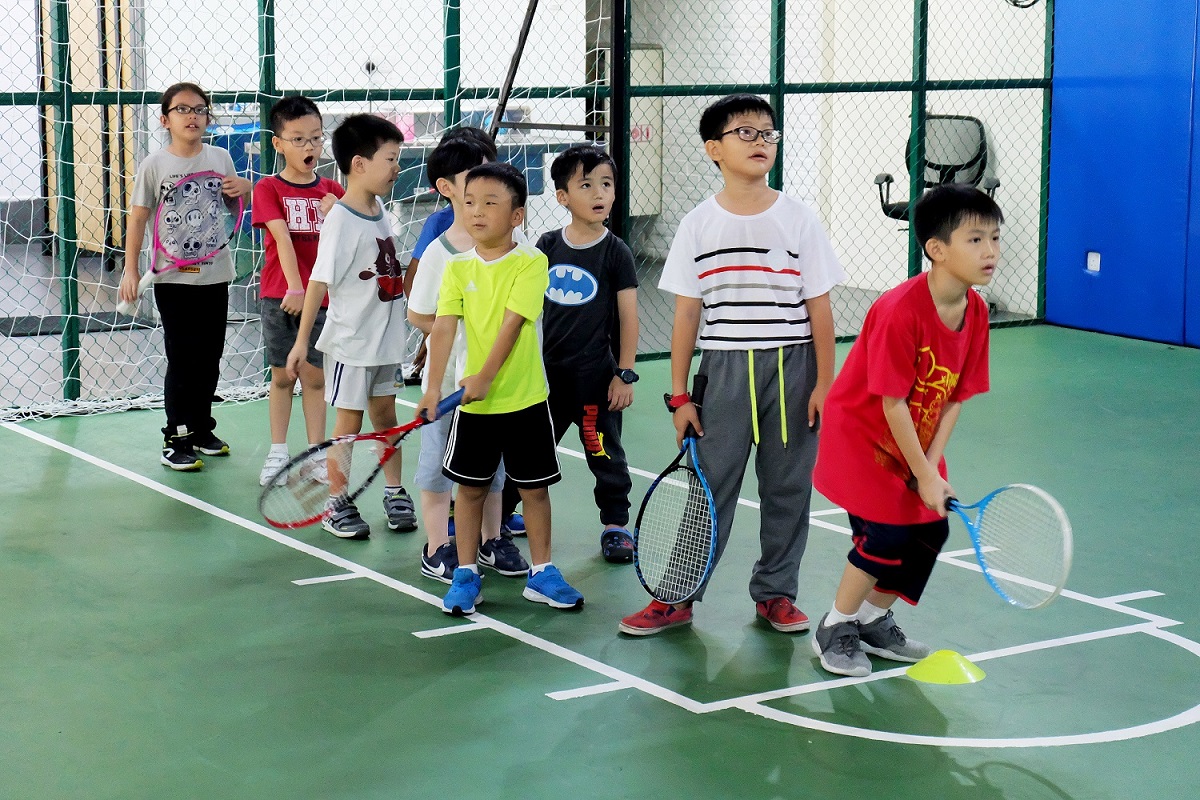 kids playing tennis at the court 