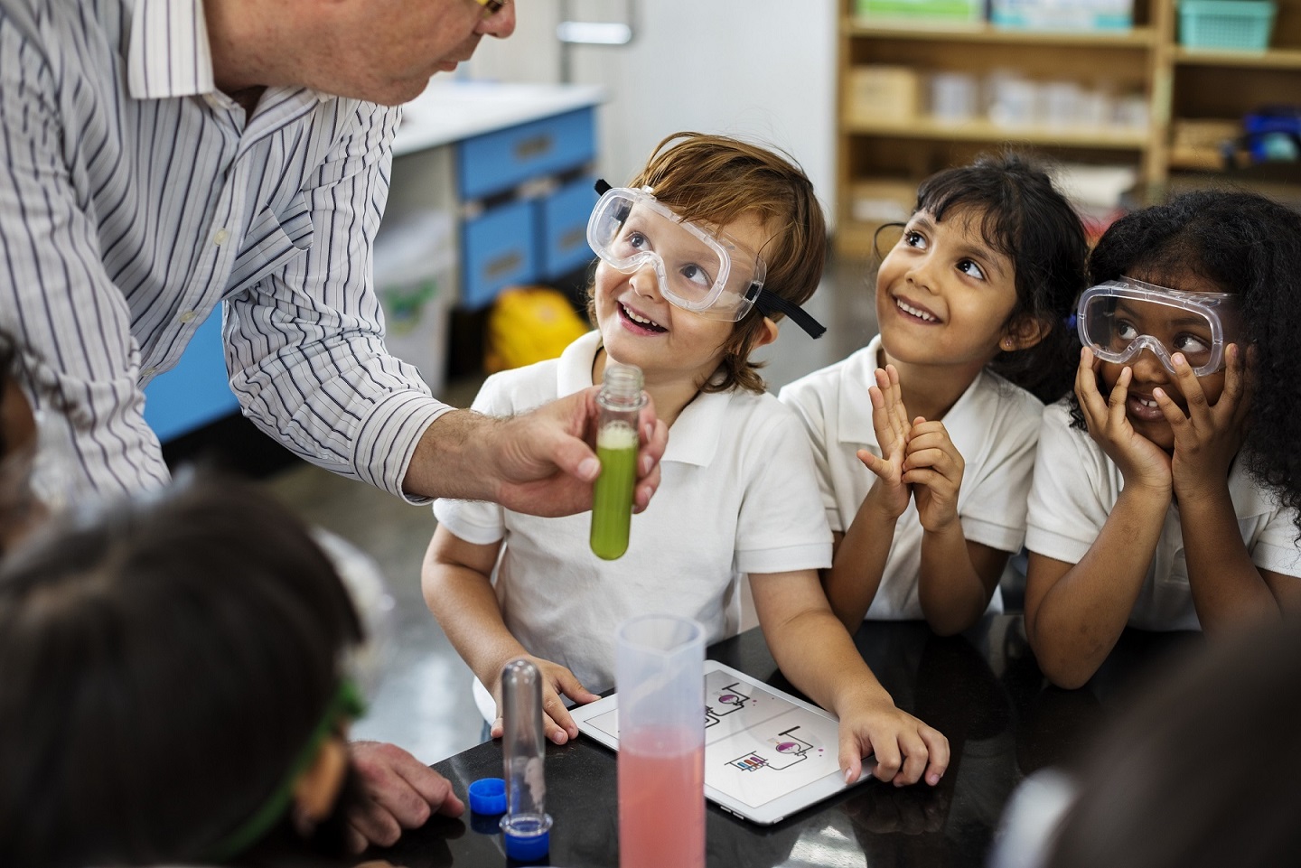 Happy kids at elementary school in science class