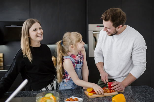 Parents teaching child how to bake