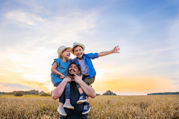 Father holding his children on his shoulders