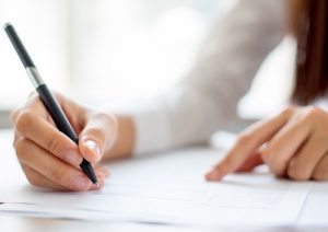 Young lady writing with a pen